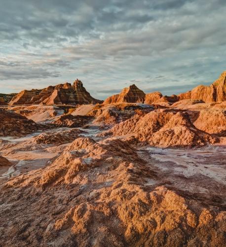 Shadows start to soften in the varied spires and buttes, cracks and crevices of Badlands National Park in morning light.