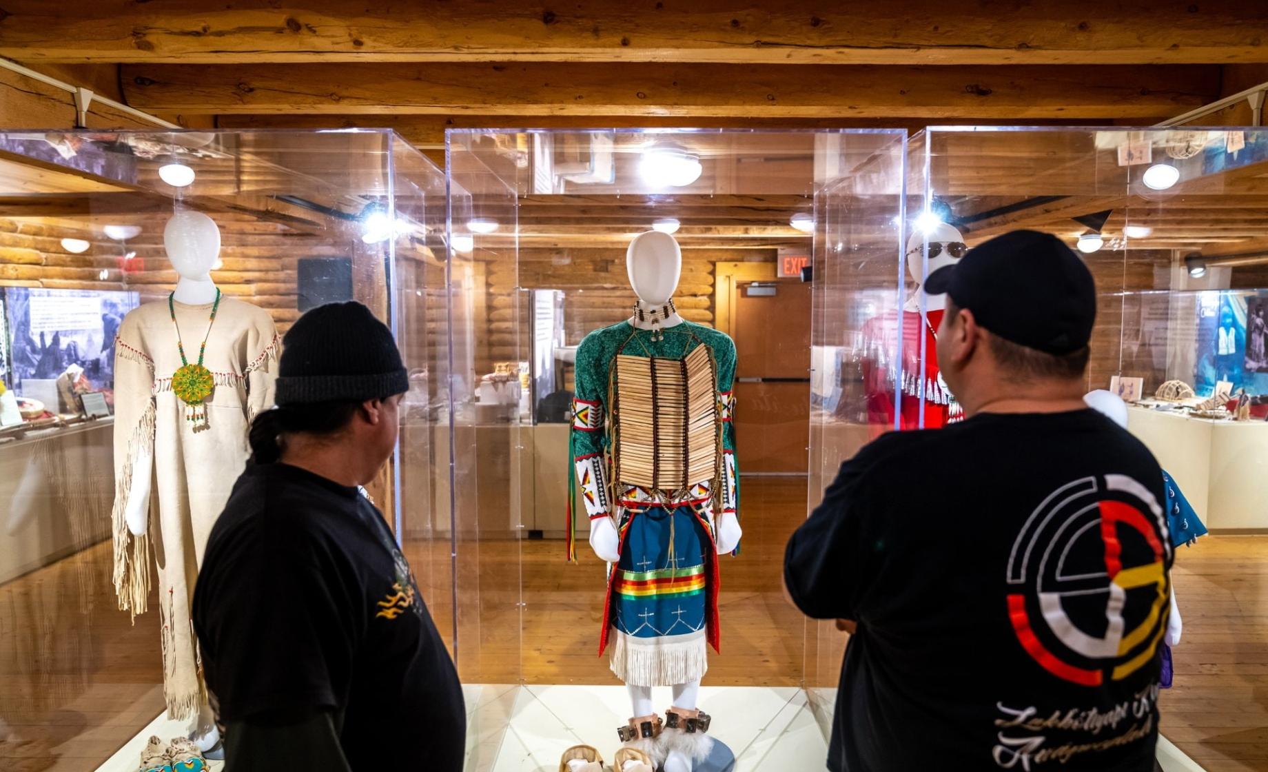 Two men looking at Native regalia on display at Crazy Horse Memorial